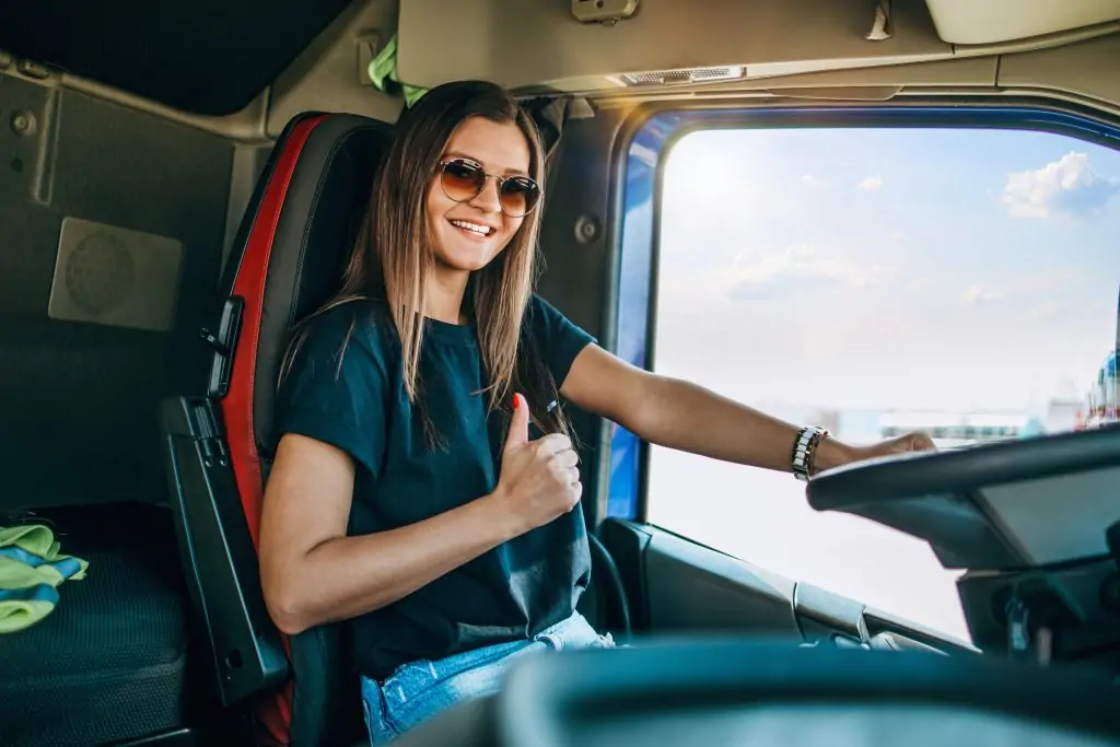 Portrait of young woman professional truck driver.